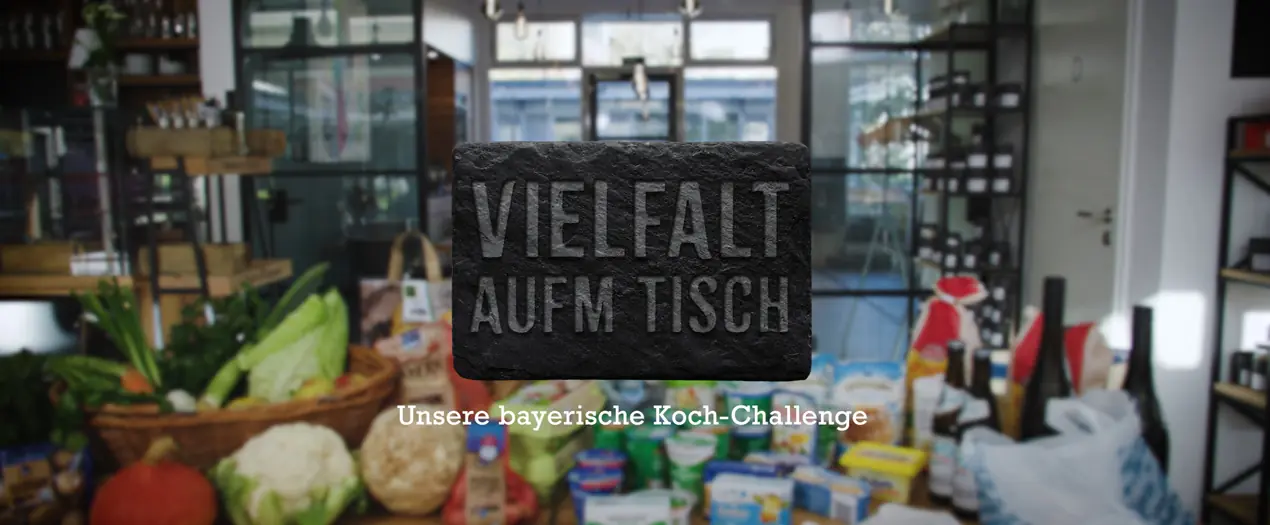 Vielfalt auf dem Tisch symbolisiert die bayerische Koch-Challenge mit frischen Zutaten im Hintergrund.