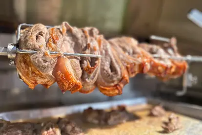 Saftig gegrillter Schweinebauch auf einem Spieß, perfekt für das bayerische Churrasco-Erlebnis.