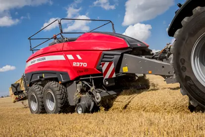Ein roter Presswagen von Massey Ferguson 2370 in einem Feld, das für moderne Agrartechnik steht.